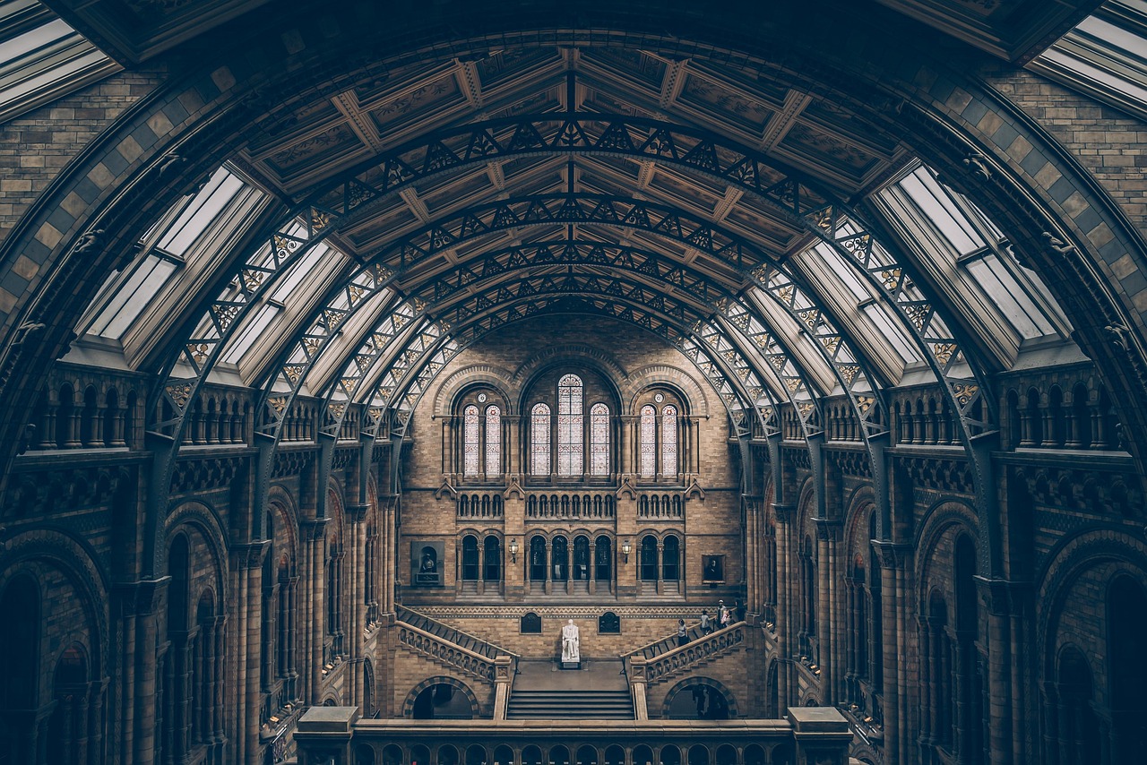 A grand hall with rows of arches and a symmetrical ceiling
